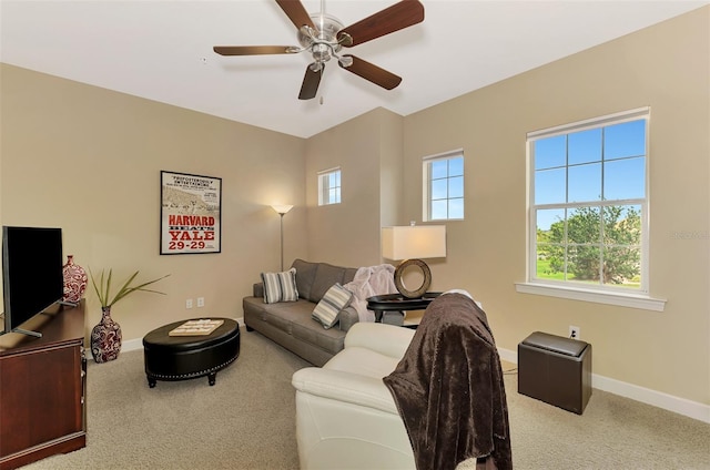 carpeted living room featuring ceiling fan