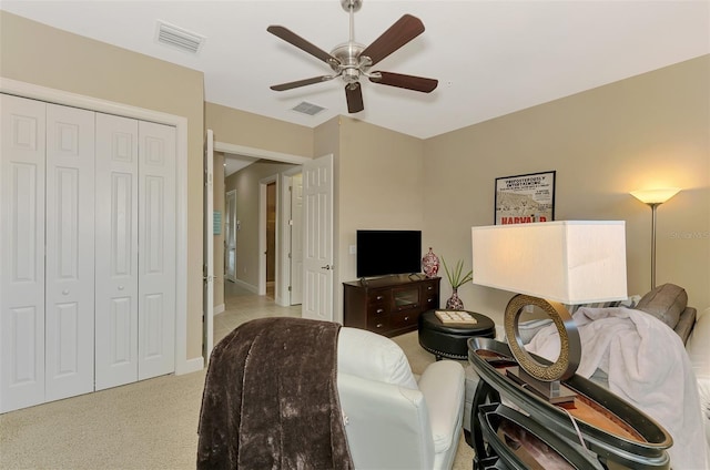 interior space with light carpet, a closet, and ceiling fan