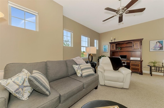 living room featuring plenty of natural light, light colored carpet, and ceiling fan