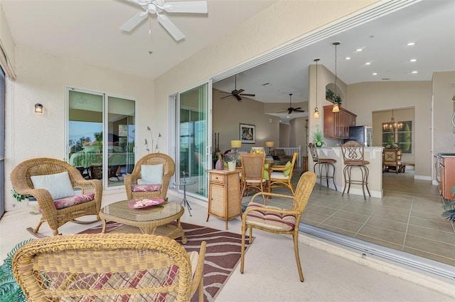 interior space with lofted ceiling and ceiling fan with notable chandelier