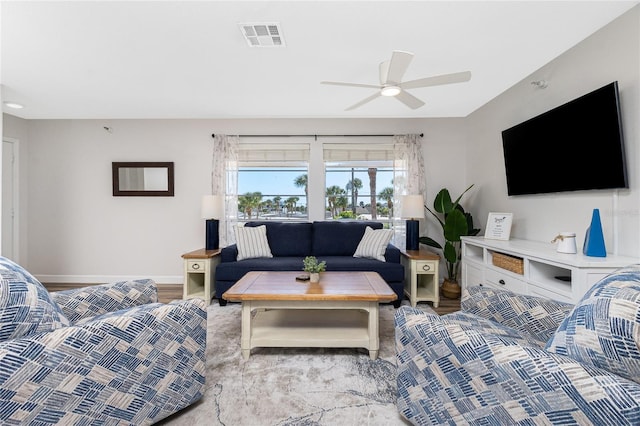 living room with ceiling fan and light hardwood / wood-style floors