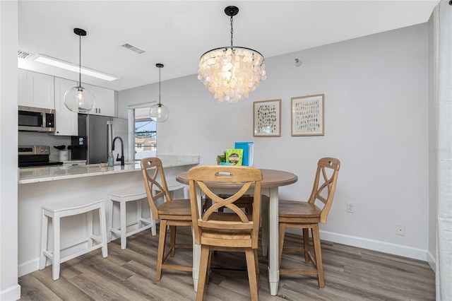 dining room featuring hardwood / wood-style flooring and sink