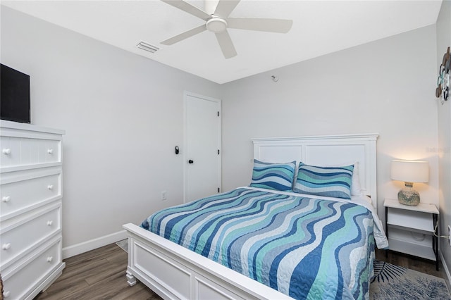 bedroom with ceiling fan and dark hardwood / wood-style flooring