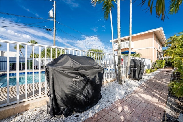 view of patio / terrace with area for grilling and a fenced in pool