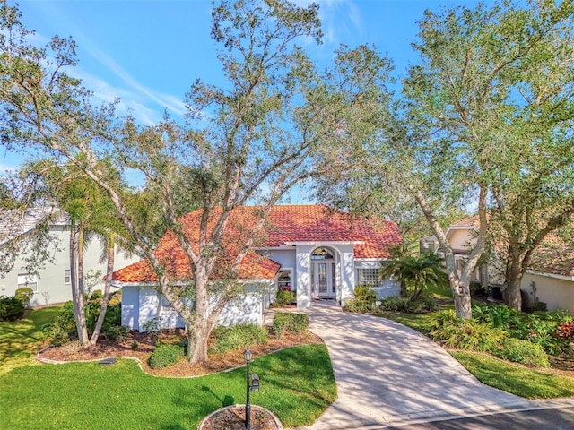 mediterranean / spanish home featuring a front yard