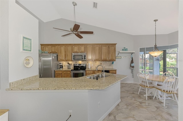 kitchen featuring tasteful backsplash, sink, light stone counters, kitchen peninsula, and stainless steel appliances