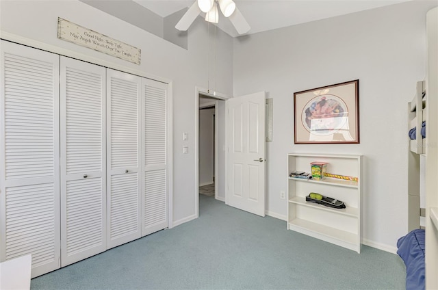 unfurnished bedroom with lofted ceiling, a closet, ceiling fan, and carpet