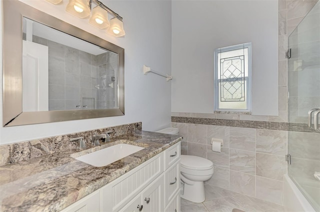 bathroom featuring vanity, tile walls, an enclosed shower, and toilet