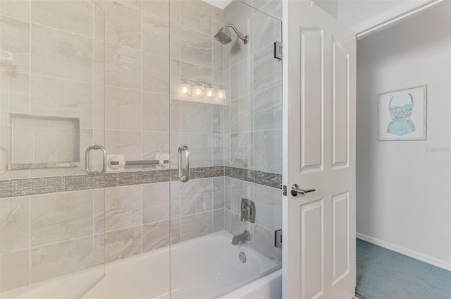 bathroom featuring combined bath / shower with glass door