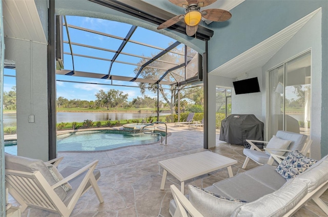 view of swimming pool with ceiling fan, area for grilling, glass enclosure, and a patio area