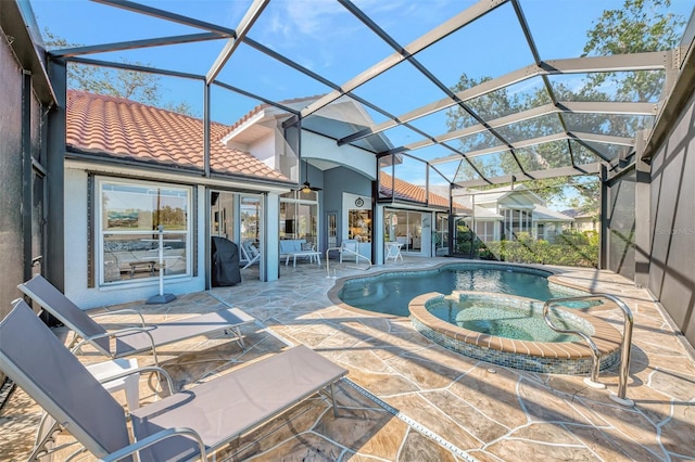 view of pool featuring an in ground hot tub, a patio, and glass enclosure