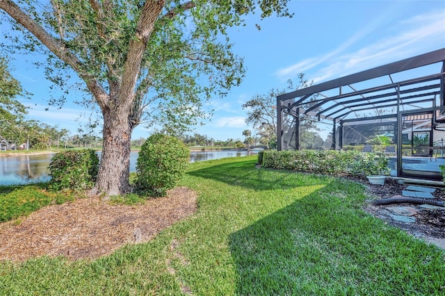 view of yard with a water view and a lanai