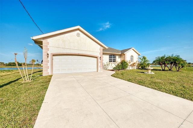 single story home with a garage, a water view, and a front yard