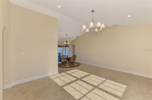 spare room featuring lofted ceiling, light tile patterned floors, and a notable chandelier