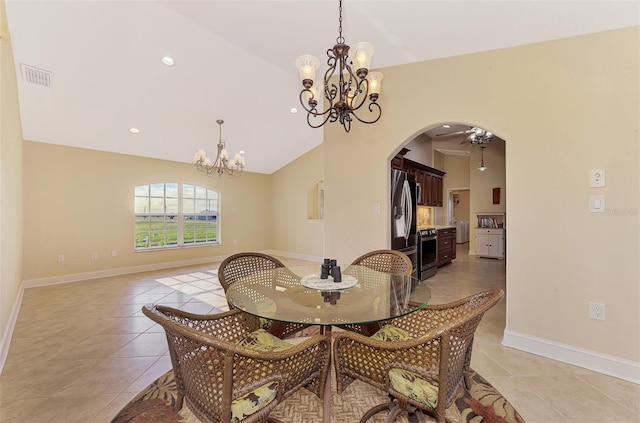 tiled dining space featuring vaulted ceiling and a notable chandelier