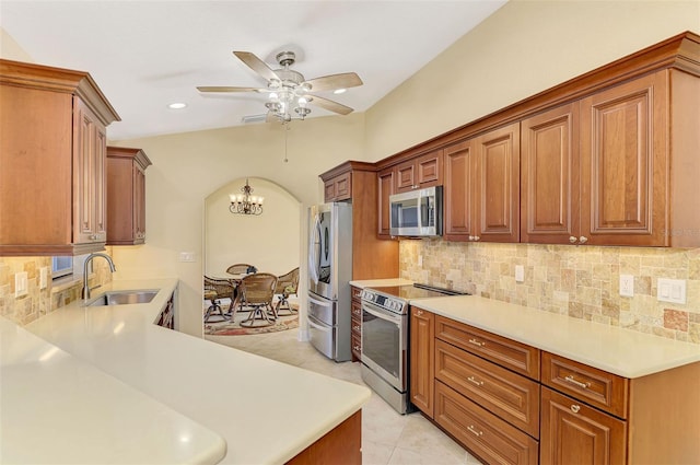 kitchen with sink, backsplash, light tile patterned flooring, and appliances with stainless steel finishes