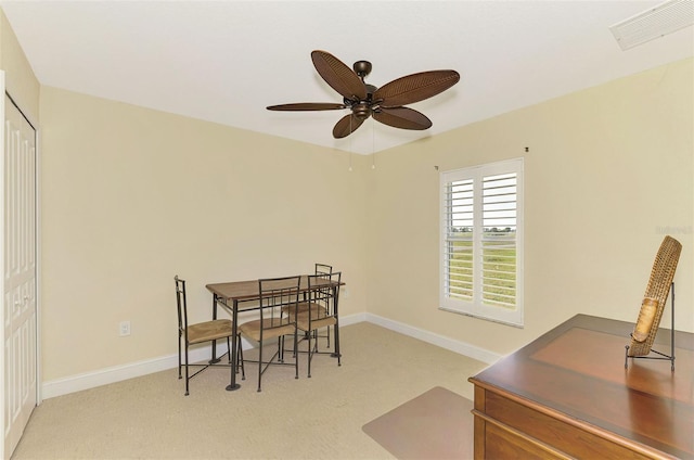 carpeted dining space featuring ceiling fan