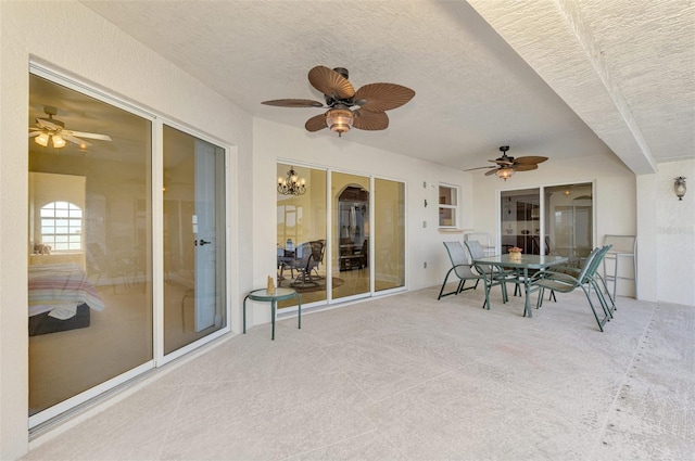 sunroom / solarium featuring a ceiling fan