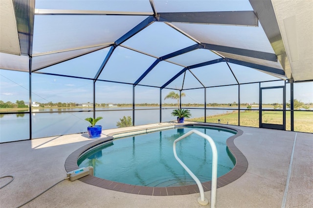 outdoor pool featuring a water view, a patio area, and glass enclosure