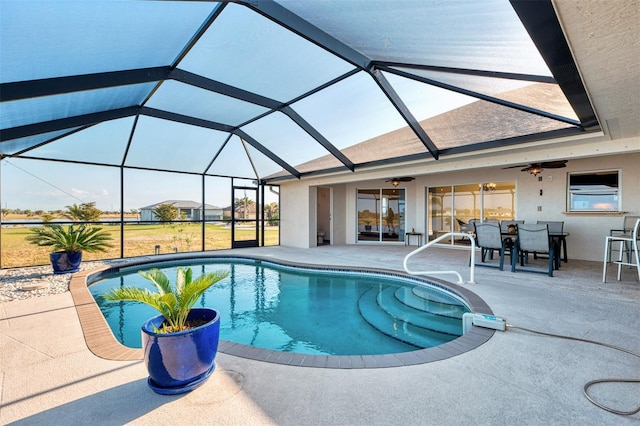 outdoor pool with glass enclosure, outdoor dining area, a patio area, and a ceiling fan