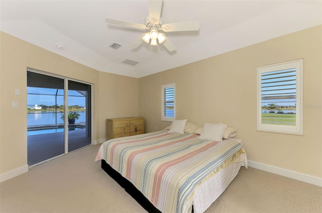 carpeted bedroom with access to outside, visible vents, ceiling fan, and baseboards