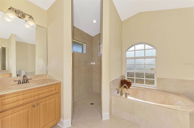 bathroom with tile patterned flooring, vaulted ceiling, a bath, and tiled shower