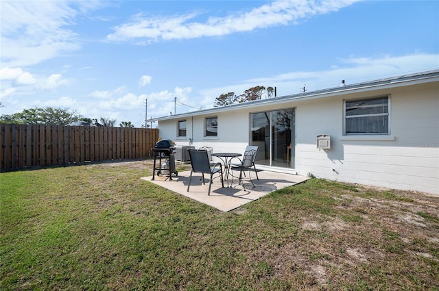 back of property with a patio and a lawn