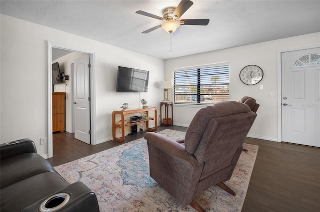 living room featuring a textured ceiling, dark hardwood / wood-style floors, and ceiling fan