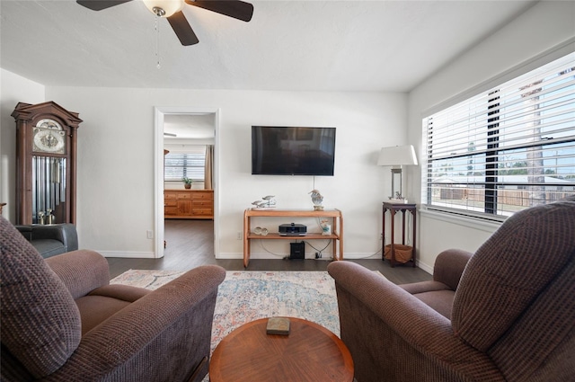 living room featuring plenty of natural light, dark wood-type flooring, and ceiling fan