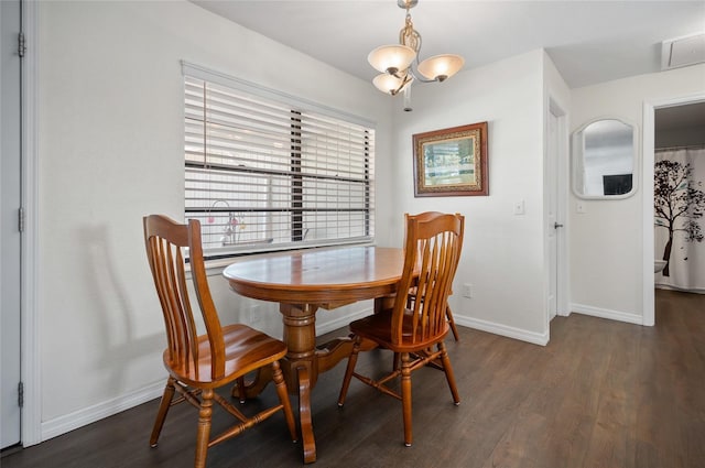 dining room featuring dark wood-type flooring and a chandelier