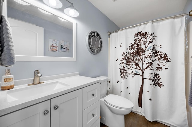 bathroom with vanity, hardwood / wood-style floors, walk in shower, and toilet