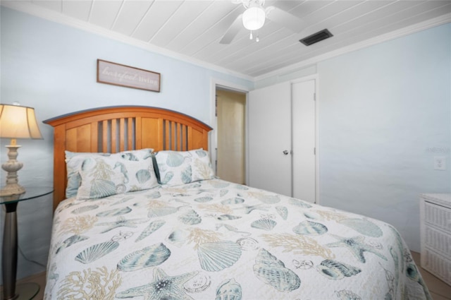 bedroom featuring crown molding, wooden ceiling, and ceiling fan