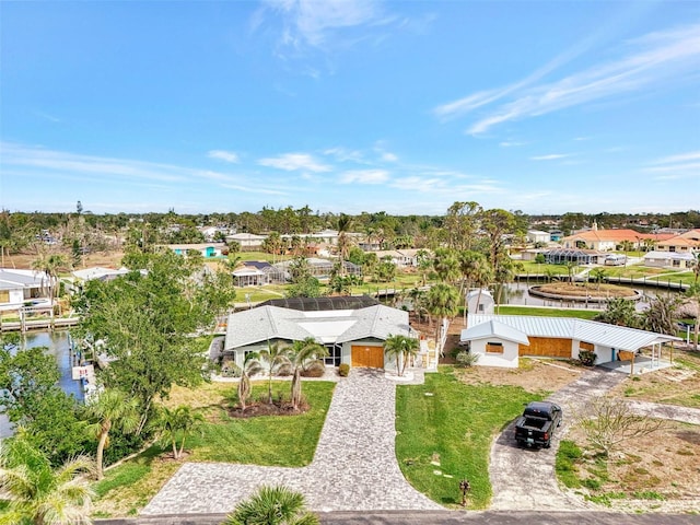 drone / aerial view featuring a residential view and a water view