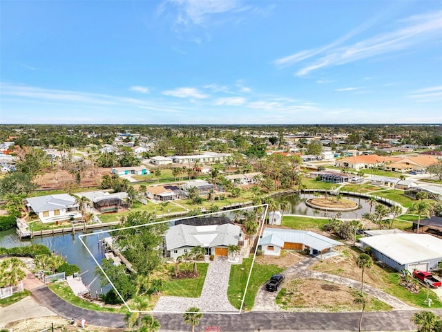 birds eye view of property with a water view and a residential view