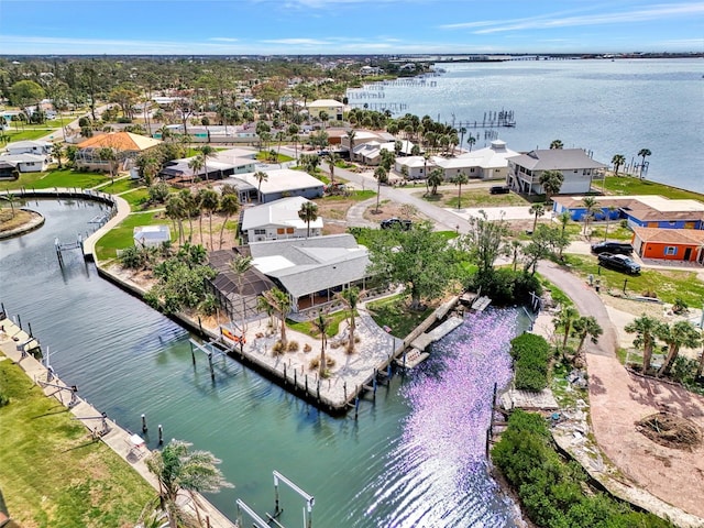 drone / aerial view with a water view and a residential view