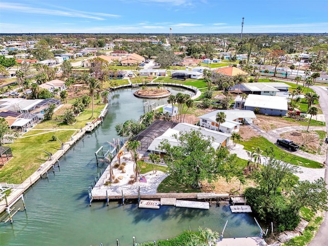 drone / aerial view featuring a water view and a residential view