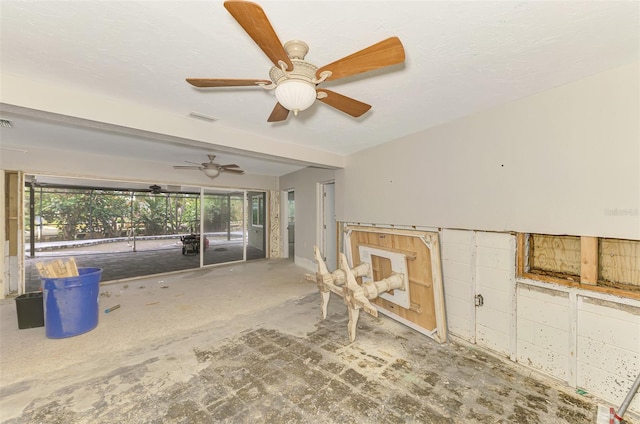 empty room with visible vents, a textured ceiling, and a ceiling fan