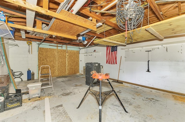 garage with a garage door opener and concrete block wall