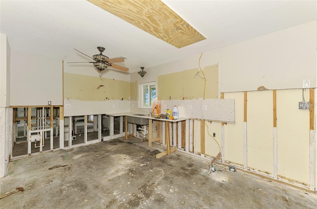 interior space featuring ceiling fan and concrete floors