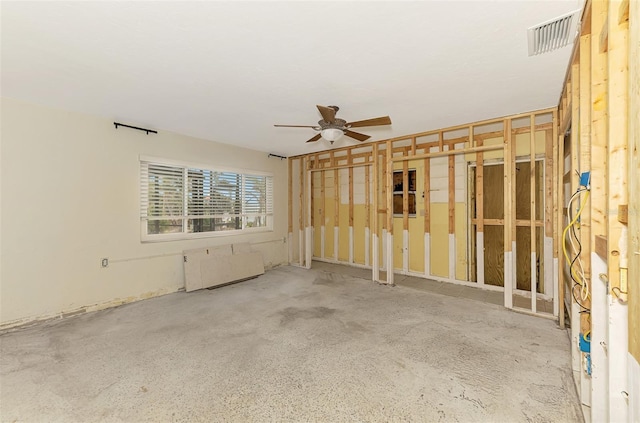 unfurnished room with a ceiling fan, radiator, and visible vents