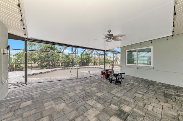 view of patio / terrace featuring glass enclosure and a ceiling fan