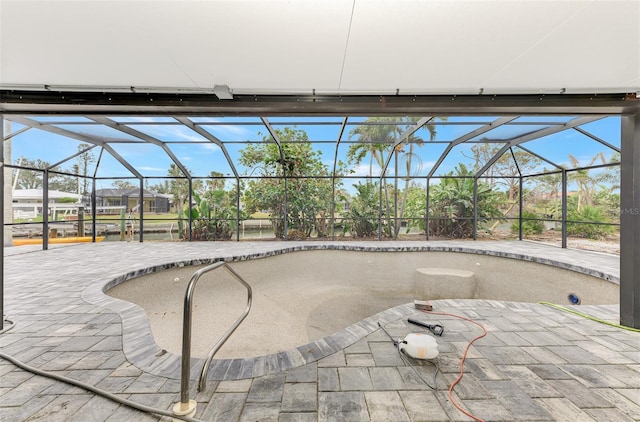 view of swimming pool featuring a patio area and a lanai