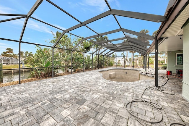 view of patio / terrace with glass enclosure and a water view