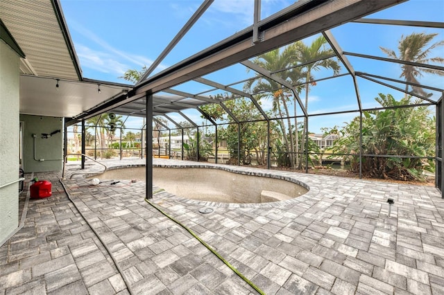 view of patio featuring glass enclosure