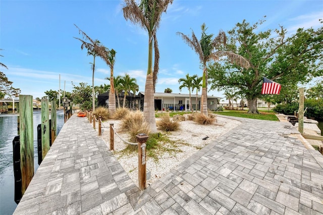 view of front of property featuring a water view and a boat dock