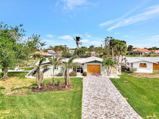 view of front of property featuring a front yard, decorative driveway, stucco siding, and a garage