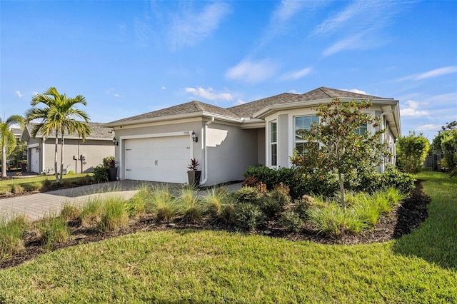 view of front facade with a garage and a front lawn