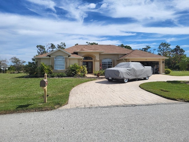 ranch-style home featuring a garage and a front yard