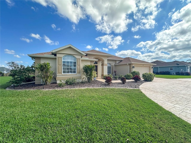 view of front of house featuring a garage and a front lawn