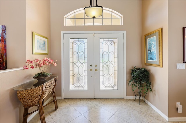 tiled foyer entrance with a wealth of natural light and french doors